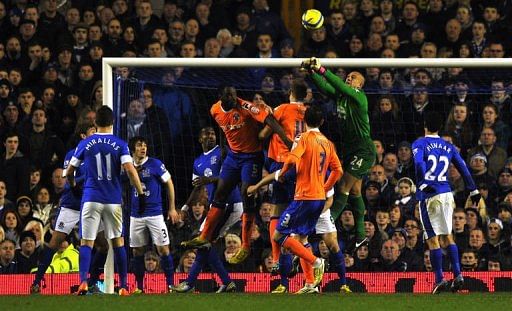 Everton's goalkeeper Tim Howard (2ndR) clears the ball at Goodison Park in Liverpool, February 26, 2013